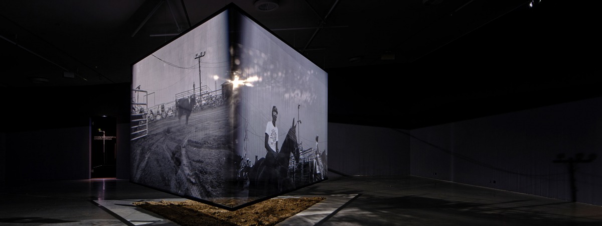 Projections on sheer fabric box for New Suns exposition