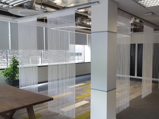 Spaghetti Bugdet string curtains by ShowTex as dividers in office workspace